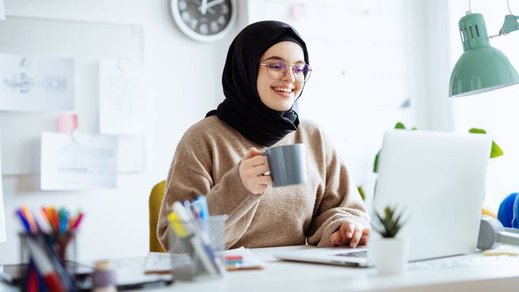 A woman looking at a laptop