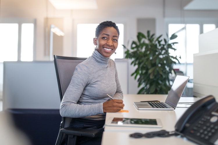 Plan Sponsor at a computer smiling