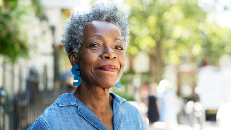 A smiling older woman with gray hair