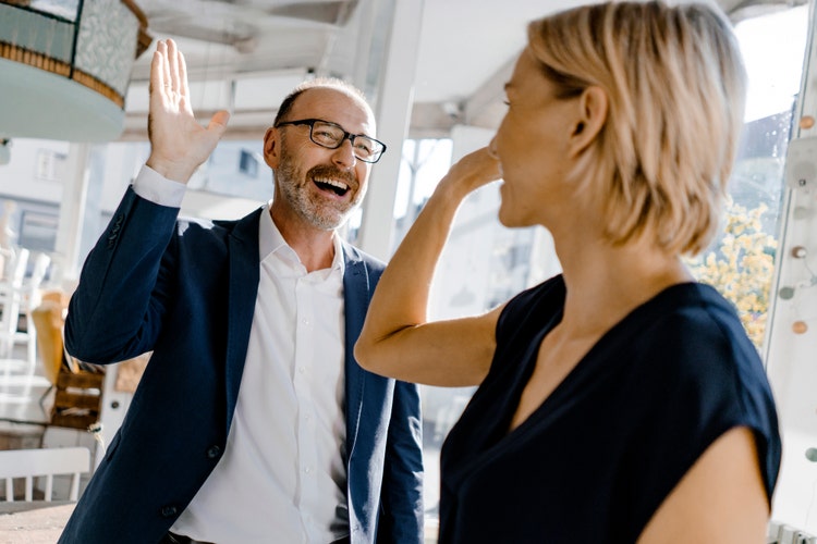 two people high-fiving