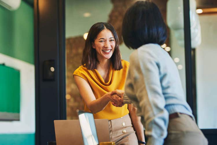 Two ladies shaking hands