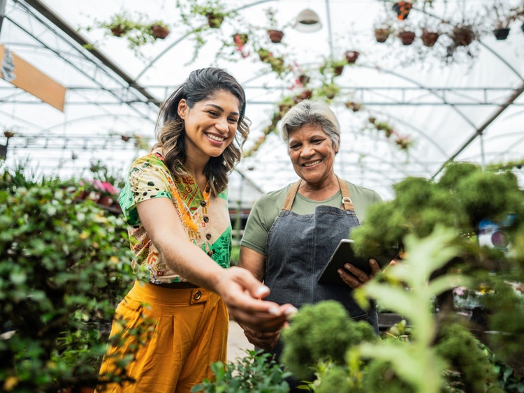 two women gardening in greenhouse
