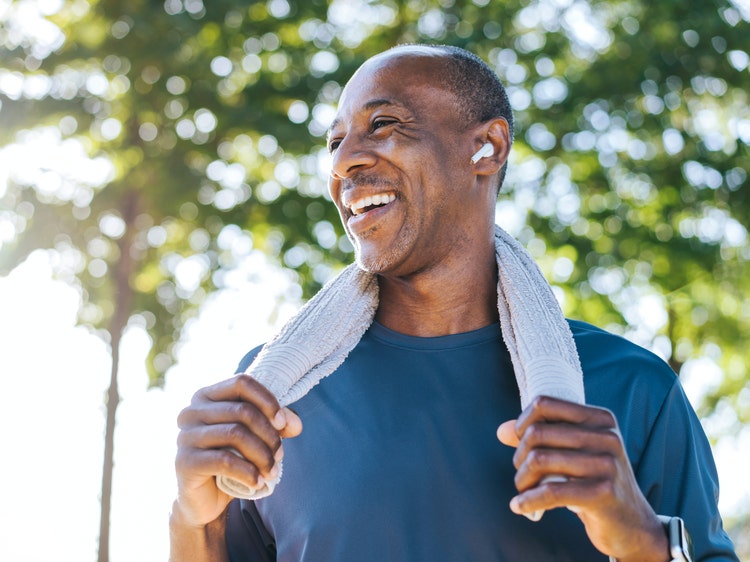 man with a towel around his neck after a run