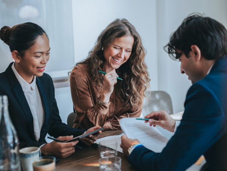 group of people reviewing investment paperwork