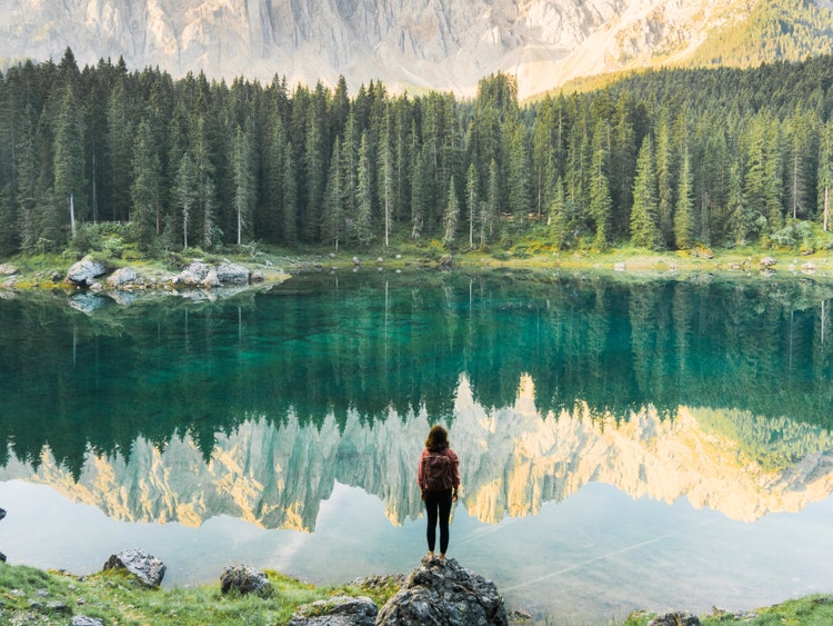 A woman standing at a pond
